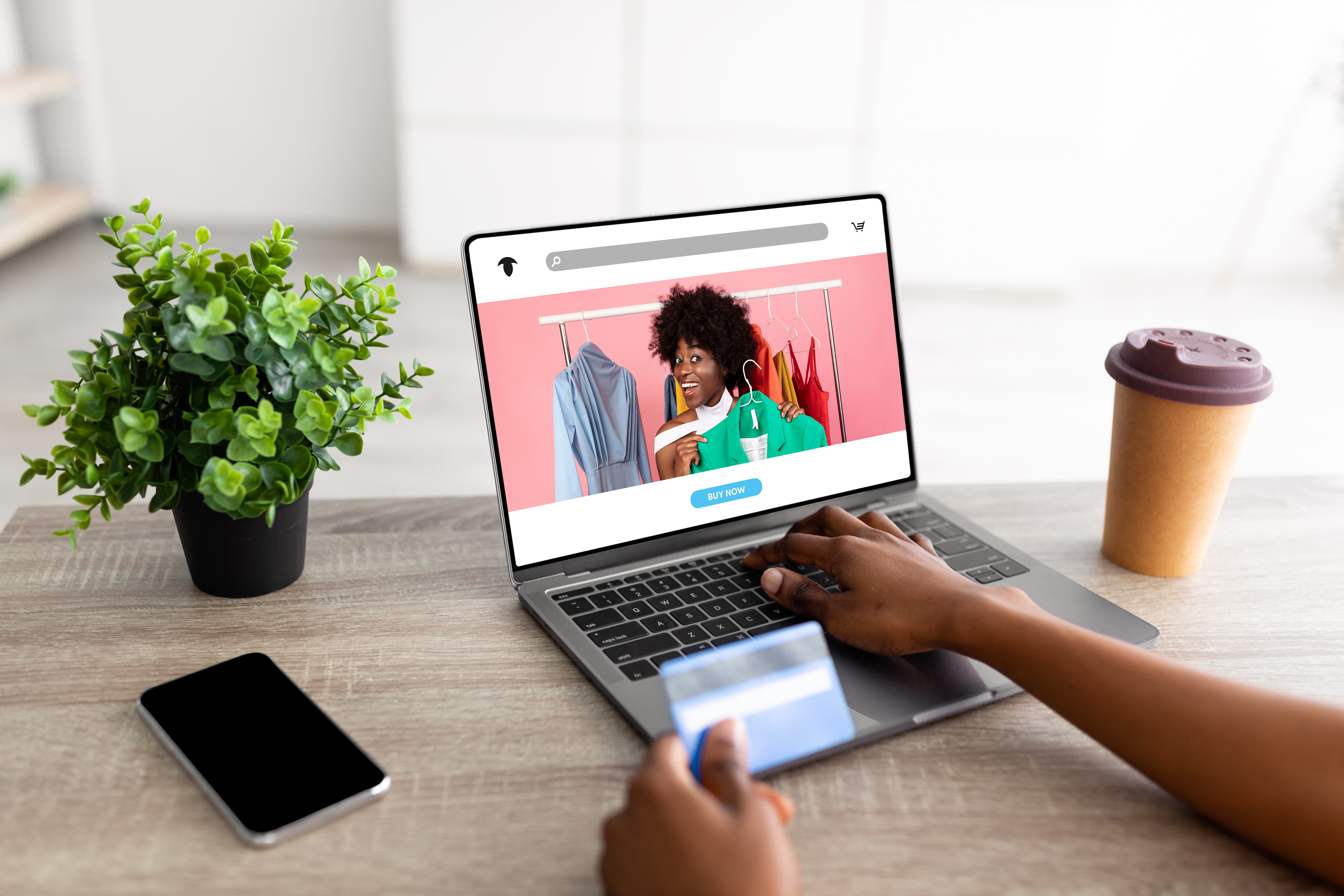 Millennial black lady with credit card, laptop and smartphone buying online on website or app. Purchasing goods in internet, online shopping and sale, banking and fashion store